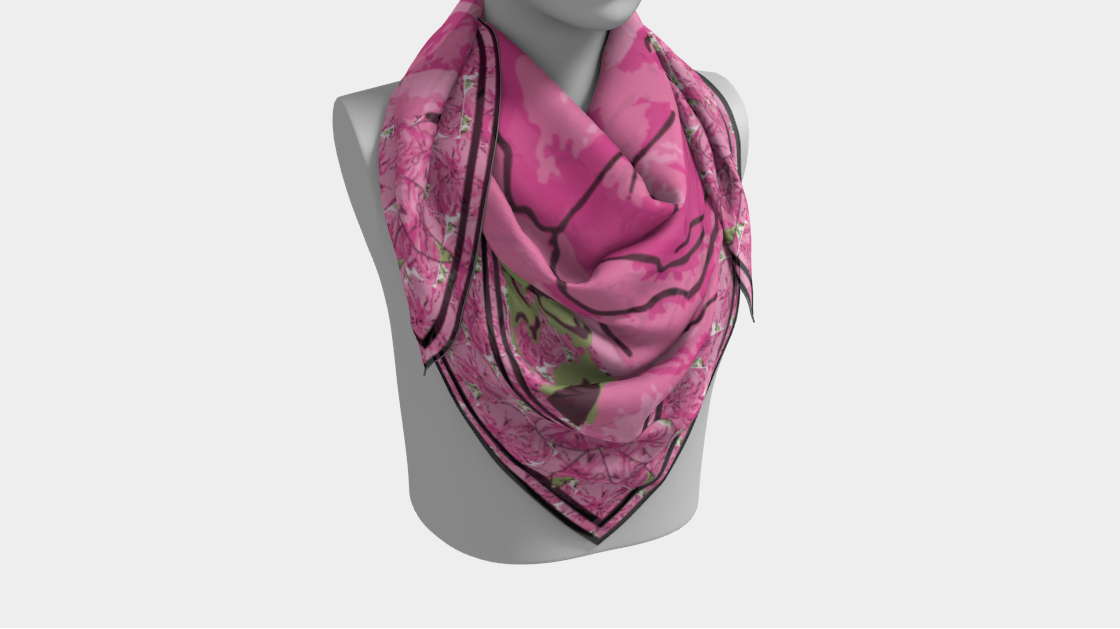 Mannequin wearing a pink scarf with floral pattern on a white background